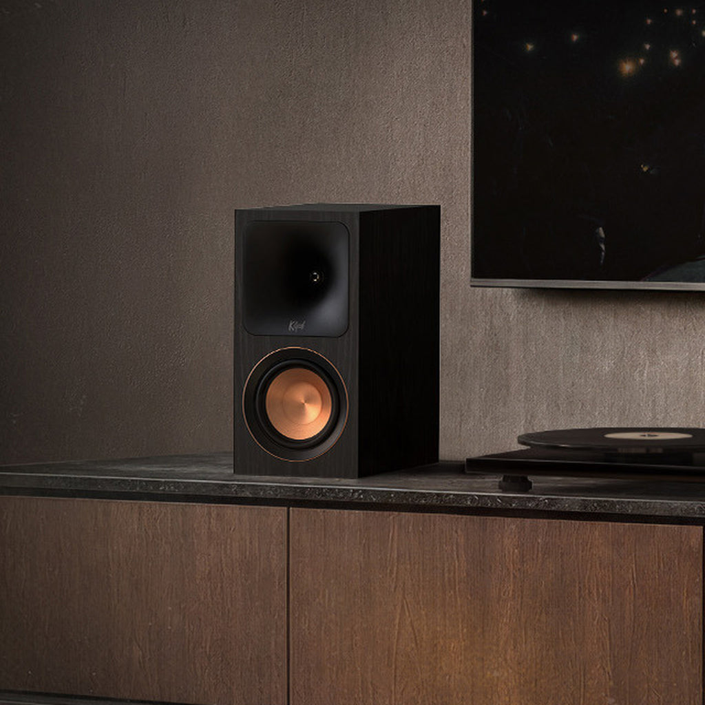 Klipsch RP-500PM powered speaker, front three-quarter angle next to a turntable